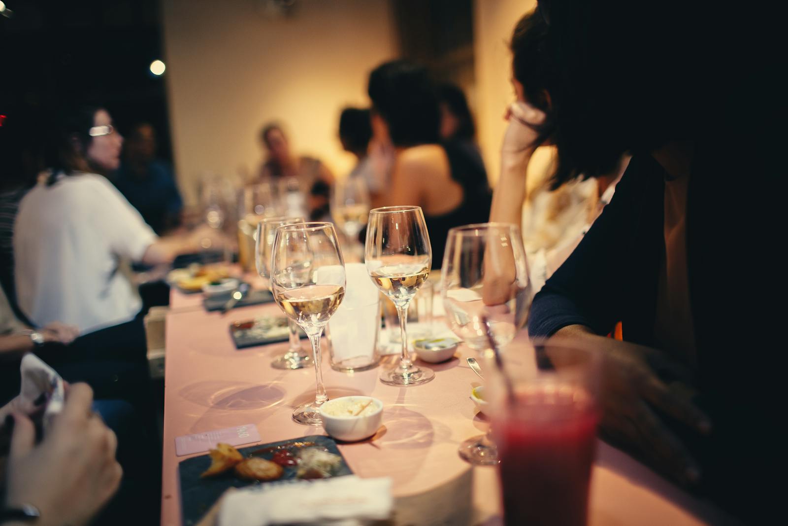 Photo by Helena Lopes A lively indoor gathering with people enjoying drinks and conversation in a Brazilian restaurant.