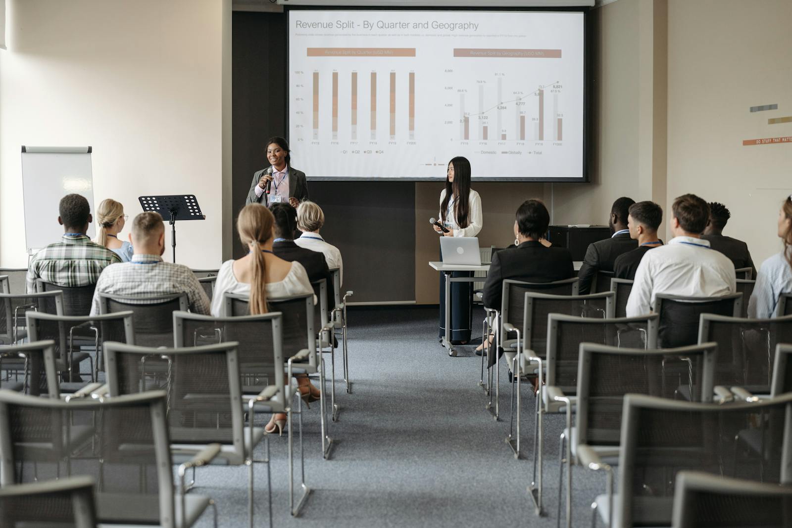 Photo by Pavel Danilyuk Professional business seminar with audience listening to presenters sharing data insights.